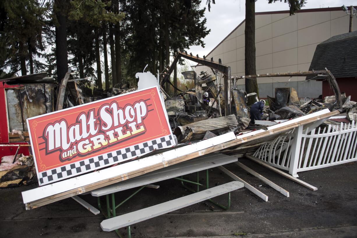 Clark County fire officials, Deputy Fire Marshall Caleb Barnes and fire inspector Rick Searls investigate the scene of a fire at the Malt Shop and Grill and the Chicken and Rib House booths at the Clark County Fairgrounds on Wednesday morning, April 11, 2018. Betty and Larry Bowman run the two booths and were planning to come to the fairgrounds today to prepare for the upcoming Home &amp; Garden Idea Fair. "It's so hard," Betty said.