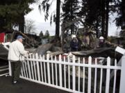 Larry Bowman of Vancouver, left, talks with fire inspector Rick Searls, center, and Deputy Fire Marshall Caleb Barnes, right, as they investigate the scene of a fire at the Malt Shop and Grill and the Chicken and Rib House booths at the Clark County Fairgrounds on Wednesday morning, April 11, 2018. Betty and Larry Bowman run the two booths, and were planning to come to the fair today to prepare for the upcoming Home &amp; Garden Idea Fair.