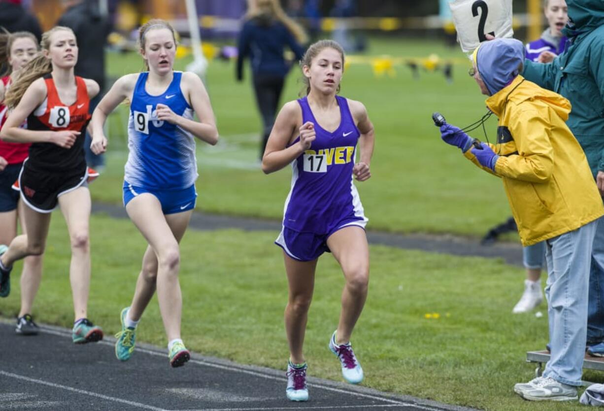 Lucy Ianello (17), a freshman at Columbia River High School, leads the pack in the 1,600 meter race. She won the 800 and 1,600 at the John Ingram Twilight meet Friday.