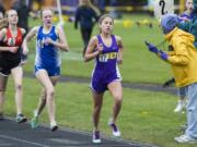 Lucy Ianello (17), a freshman at Columbia River High School, leads the pack in the 1,600 meter race. She won the 800 and 1,600 at the John Ingram Twilight meet Friday.