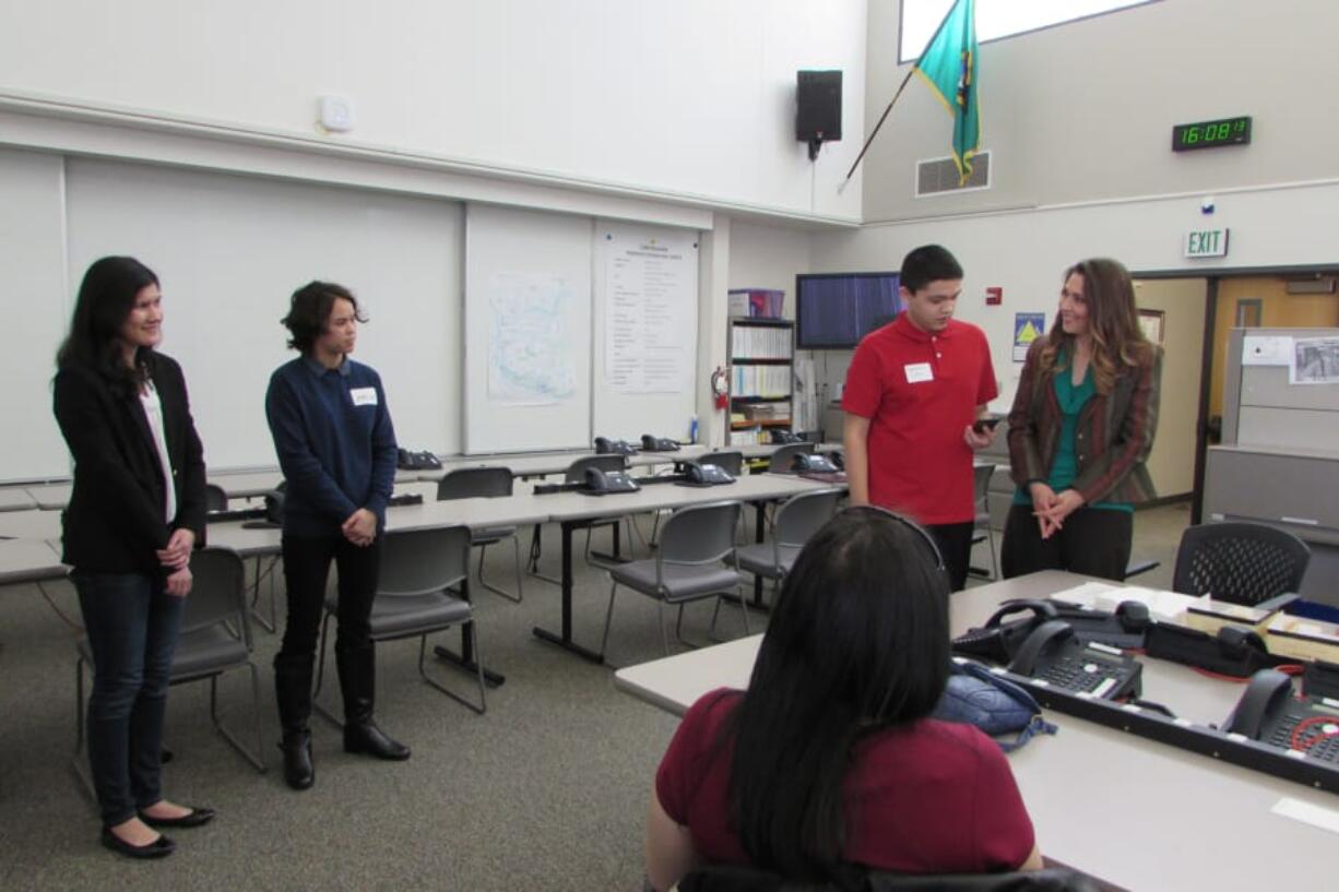 Felida: Skyview High School students, from left, Kristen Stilin, Amelia Madarang and Nathan Chen show Rep. Jaime Herrera Beutler, R-Battle Ground, their app titled “Duck & Cover,” for which they won a Congressional STEM App Competition award.