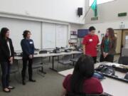 Felida: Skyview High School students, from left, Kristen Stilin, Amelia Madarang and Nathan Chen show Rep. Jaime Herrera Beutler, R-Battle Ground, their app titled “Duck & Cover,” for which they won a Congressional STEM App Competition award.