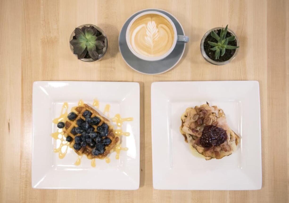 The JG2 waffle topped with lemon curd and organic blueberries, left, and the Couve Club waffle topped with honey maple turkey, Havarti, bacon and raspberry preserves, right, at the Syrup Trap in downtown Vancouver. Syrup Trap serves Belgian-style Liege waffles.