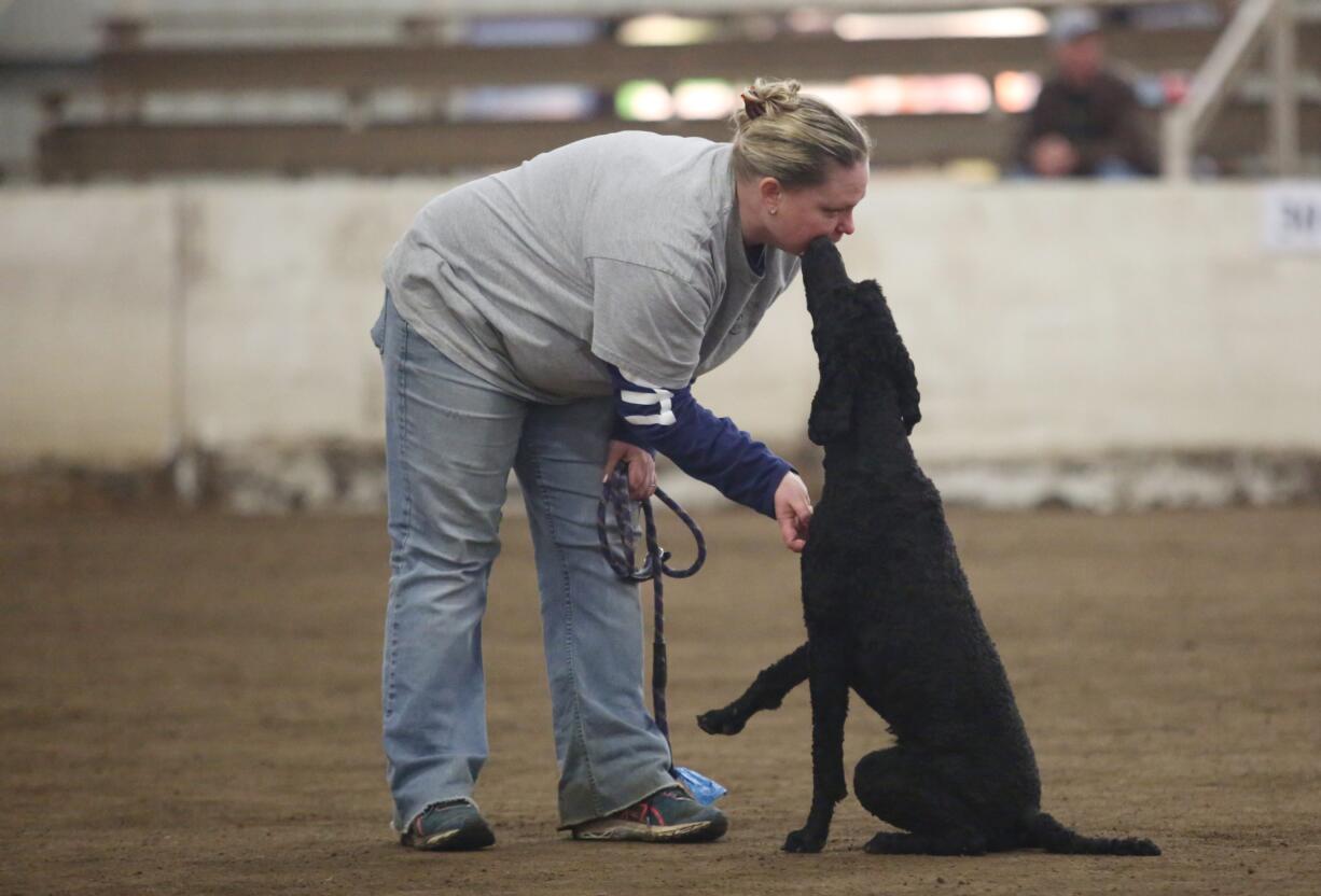 Michelle Voldeman gets a smooch from her dog Visby as they take part in agility trials.