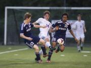 Columbia River’s Jake Connop (14) sneaks between Mark Morris’ Ethan West (13) and Kodee Soetamin (15) during the 2A GSHL match at Kiggins Bowl on Tuesday. Connop had a goal and an assist in River’s 4-0 victory.