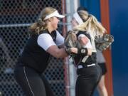 Woodland pitcher Olivia Grey, left, celebrates with Justice Holcomb after winning their game against Ridgefield at Ridgefield High School, Thursday April 26, 2018.