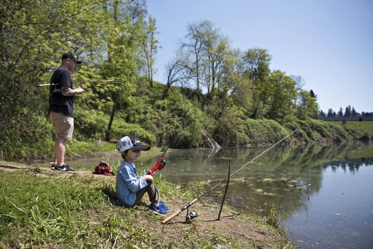 Adam Resendiz of Vancouver and his son Abraham, 4, fish together at Klineline Pond in Vancouver on Wednesday afternoon.