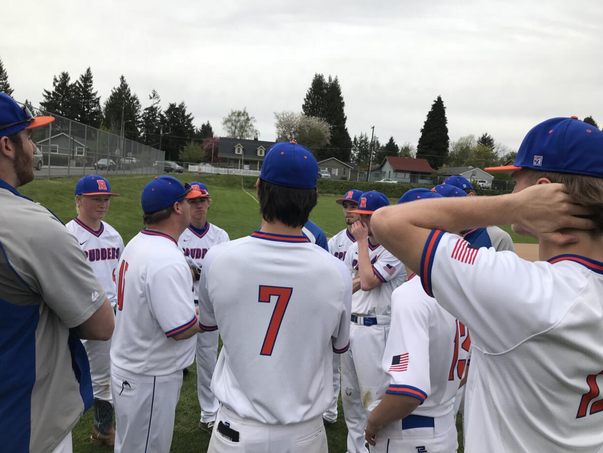 Head coach Nick Allen (left) speaks to his Ridgefield baseball team after Friday’s 14-7 home win over Hockinson.