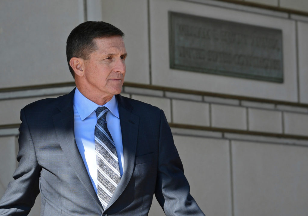 FILE - In this Dec. 1, 2017, file photo, former national security adviser Michael Flynn for President Donald Trump leaves federal court in Washington. Robert Mueller’s Russia investigation is illustrating an age-old truism: It pays to cooperate with the government. The few people who so have cooperated with the special counsel’s office have enjoyed perks including the prospect of reduced prison sentences.  Flynn flies cross-country to stump for a California congressional candidate and books a speaking event in New York.