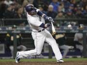 Seattle Mariners' Mitch Haniger connects on a 2-RBI single against the Oakland Athletics in the third inning during a baseball game Saturday, April 14, 2018, in Seattle.