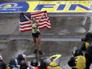 Desiree Linden, of Washington, Mich., celebrates after winning the women's division of the 122nd Boston Marathon on Monday, April 16, 2018, in Boston. She is the first American woman to win the race since 1985.