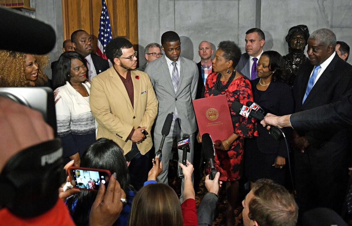 James Shaw Jr., who was injured when he disarmed a shooter inside a Nashville-area Waffle House, stands with family and friends at a press conference after he was honored at the Tennessee State House Tuesday, April 24, 2018, in Nashville, Tenn.