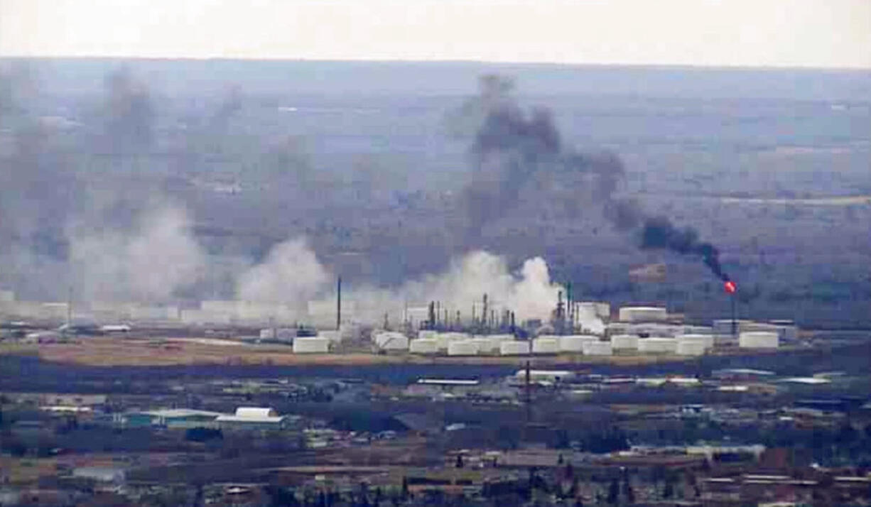 This image from video provided by WDIO-TV in Duluth shows smoke rising from the Husky Energy oil refinery after an explosion Thursday morning, April 26, 2018 in Superior, Wis. Authorities say several people were injured in the explosion.