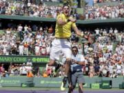 John Isner celebrates after defeating Alexander Zverev, of Russia, during the final at the Miami Open tennis tournament Sunday, April 1, 2018, in Key Biscayne, Fla. John Isner won the biggest title of his 14-year career on Sunday, holding every service game and rallying past Zverev in the Miami Open final, 6-7 (4), 6-4, 6-4.