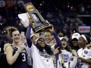 Notre Dame's Arike Ogunbowale holds the trophy after defeating Mississippi State in the final of the women's NCAA Final Four college basketball tournament, Sunday, April 1, 2018, in Columbus, Ohio. Notre Dame won 61-58.