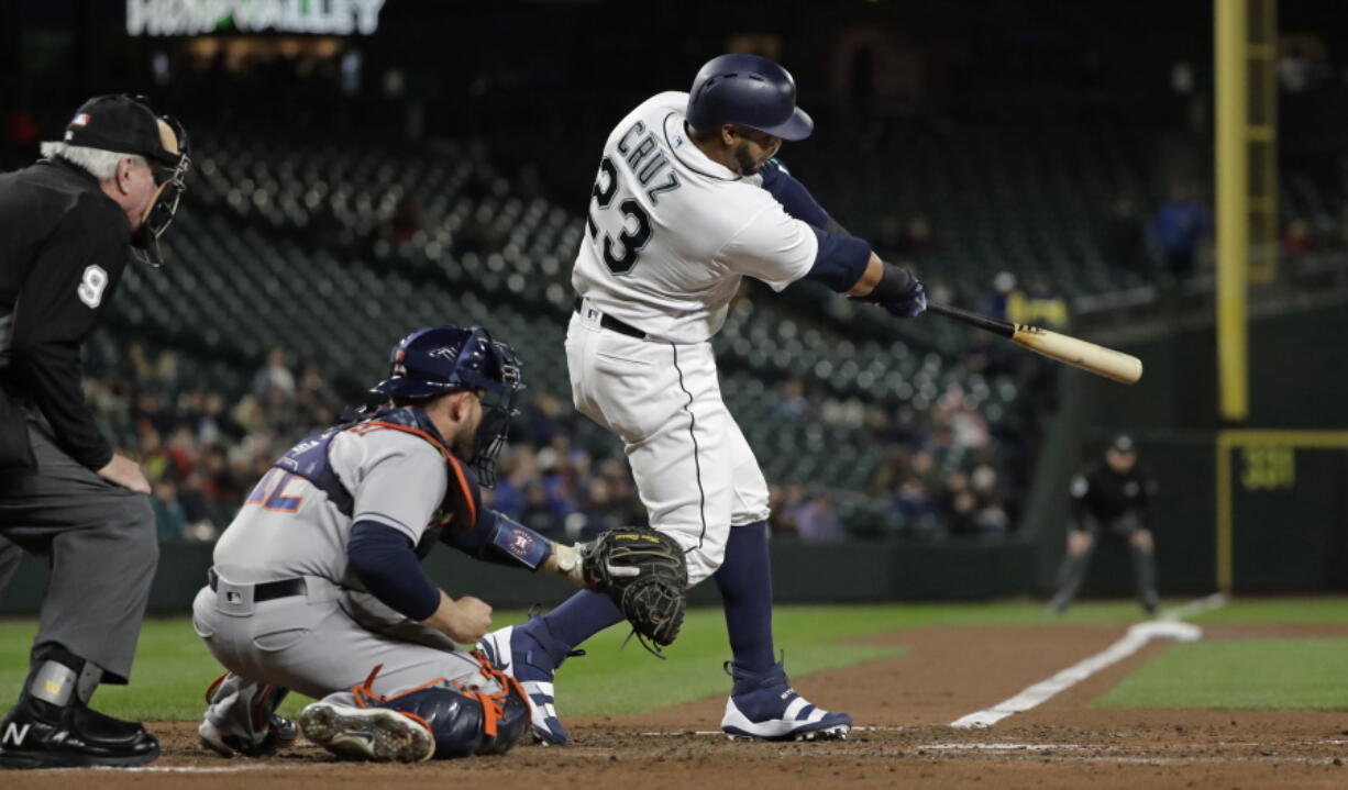 Seattle Mariners’ Nelson Cruz hits a solo home run against the Houston Astros in the fourth inning of a baseball game, Monday, April 16, 2018, in Seattle. (AP Photo/Ted S.