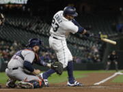 Seattle Mariners’ Nelson Cruz hits a solo home run against the Houston Astros in the fourth inning of a baseball game, Monday, April 16, 2018, in Seattle. (AP Photo/Ted S.