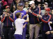 Ryan Harrison, of the United States, celebrates with teammates after beating Ruben Bemelmans, of Belgium, in a Davis Cup quarterfinal singles tennis match Sunday, April 8, 2018, in Nashville, Tenn. The United States clinched the series Saturday to move on to the semifinals.