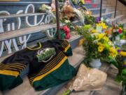 A memorial at the stairs that lead to Elgar Petersen Arena is shown in Humboldt, Saskatchewan, on Saturday, April 7, 2018. Royal Canadian Mounted Police say 14 people are dead and others injured Friday after a truck collided with a bus carrying a junior hockey team to a playoff game in northeastern Saskatchewan. Police say there were 28 people including the driver on board the Humboldt Broncos bus when the crash occurred at around 5 p.m. on Highway 35 north of Tisdale.