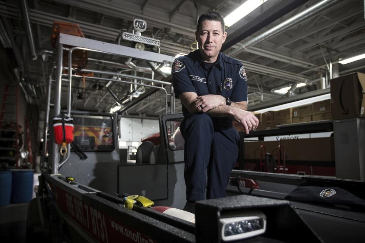 Pat Gjerde, a Monroe firefighter, stands on a rescue boat used for water rescue operations at the Monroe Fire Department on March 29 in Monroe.