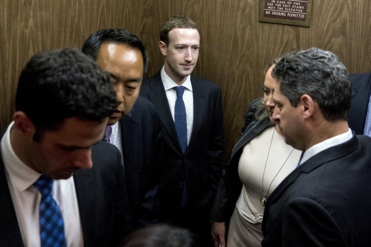 Facebook CEO Mark Zuckerberg, center, leaves a meeting with Sen. John Thune, R-S.D. on Capitol Hill in Washington on Monday. Zuckerberg will testify Tuesday before a joint hearing of the Commerce and Judiciary Committees about the use of Facebook data to target American voters in the 2016 election.