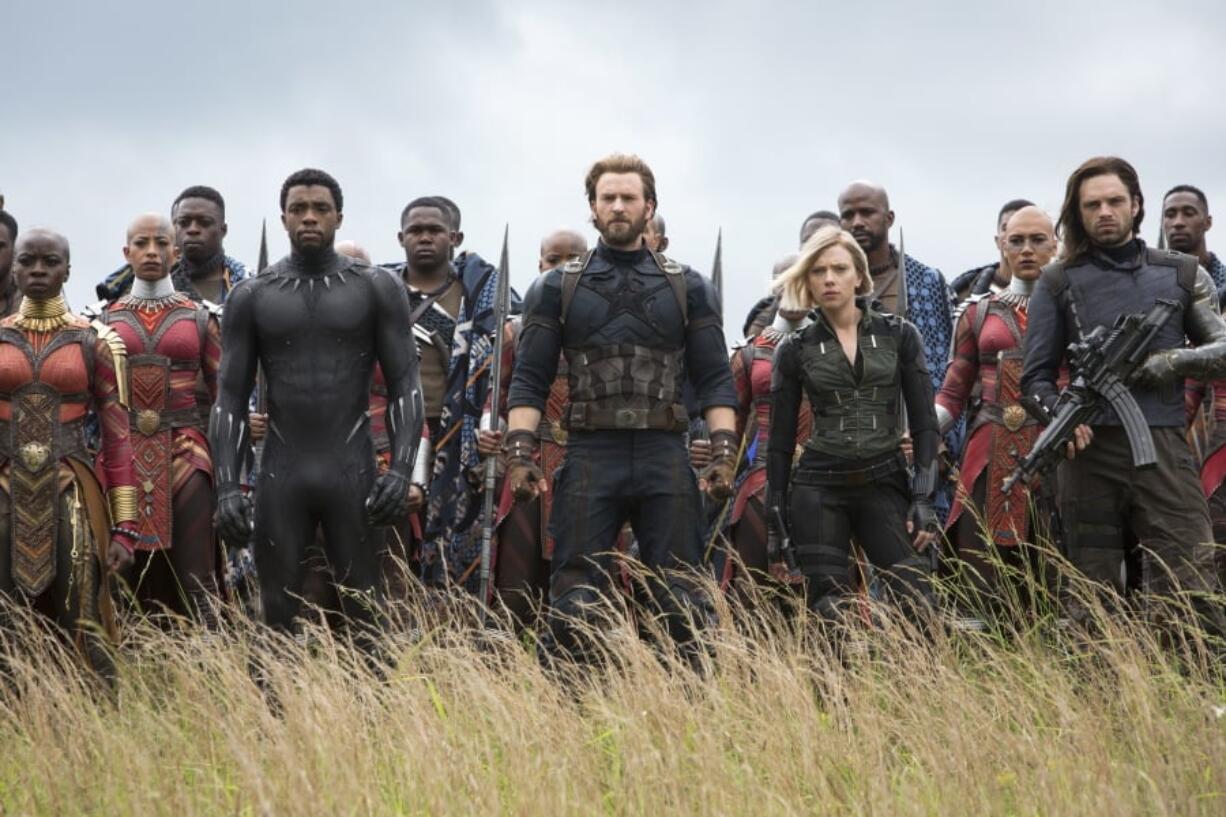 This image released by Marvel Studios shows, front row from left, Danai Gurira, Chadwick Boseman, Chris Evans, Scarlet Johansson and Sebastian Stan in a scene from “Avengers: Infinity War,” premiering on April 27.