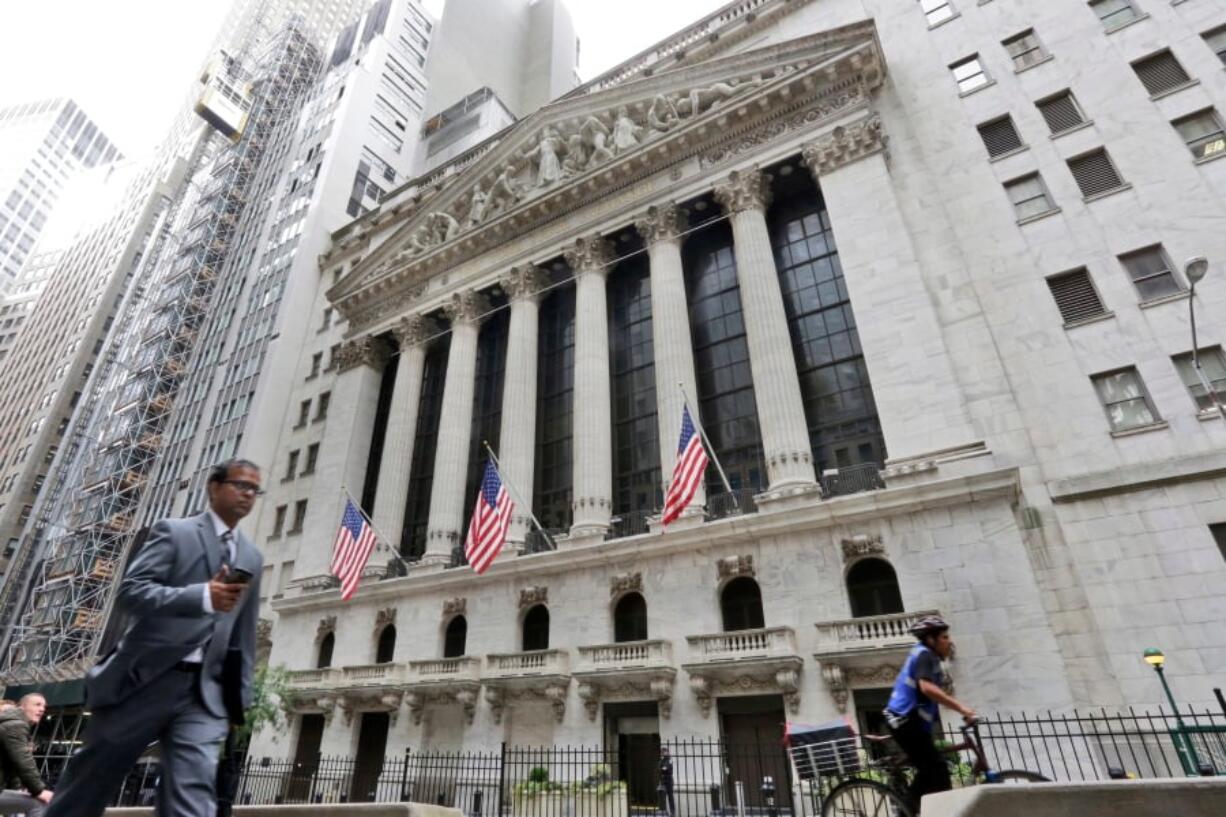 FILE- In this Oct. 24, 2017, file photo, people pass the New York Stock Exchange. The U.S. stock market opens at 9:30 a.m. EDT on Thursday, April 26, 2018.