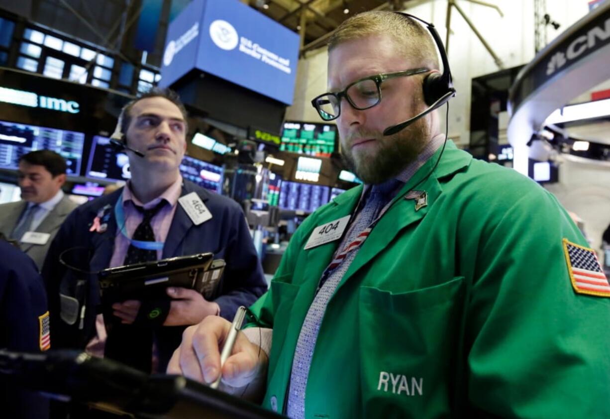 Traders Gregory Rowe, left, and Ryan Falvey work on the floor of the New York Stock Exchange, Thursday, April 5, 2018. Stocks are opening higher on Wall Street as the market builds on a solid gain from late in the day before.