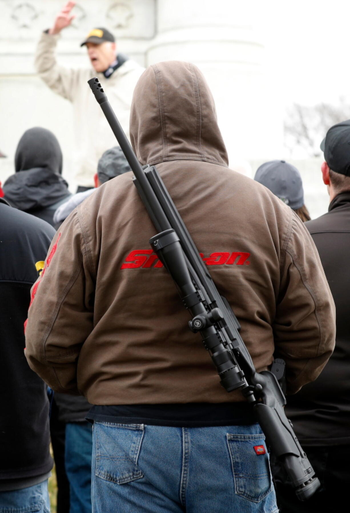 People listen to a speaker at a gun rights rally Saturday in Des Moines, Iowa.