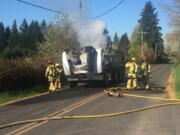 Firefighters with Clark County Fire and Rescue inspect a dump truck that caught fire Thursday morning near the 4500 block of Northwest 199th Street south of Ridgefield.