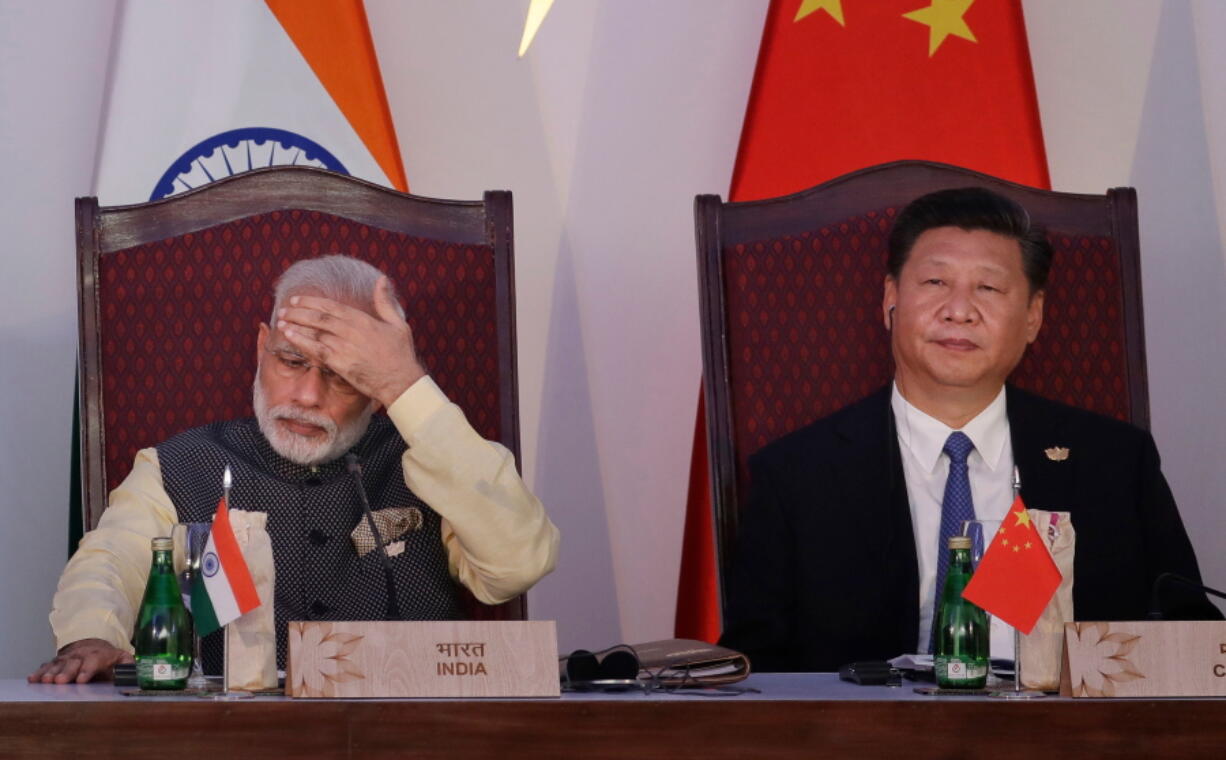 Indian Prime Minister Narendra Modi, left, and Chinese President Xi Jinping attend the BRICS summit in Goa, India. Modi is travelling April 27-28, 2018 to meet with Xi for a visit that some experts have described as a possible way to reset a complicated relationship between the two Asian powers that has faced several tests last year, including a tense border standoff.