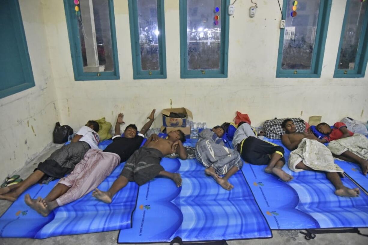 Ethnic-Rohingya men rescued in Indonesian waters sleep at a temporary shelter in Bireuen, Aceh province, Indonesia, Saturday, April 21, 2018. Indonesian fishermen rescued dozens of Rohingya Muslims stranded off the coast of Aceh on Friday, authorities said, in the latest attempt by members of the persecuted ethnic group to flee Myanmar by sea.