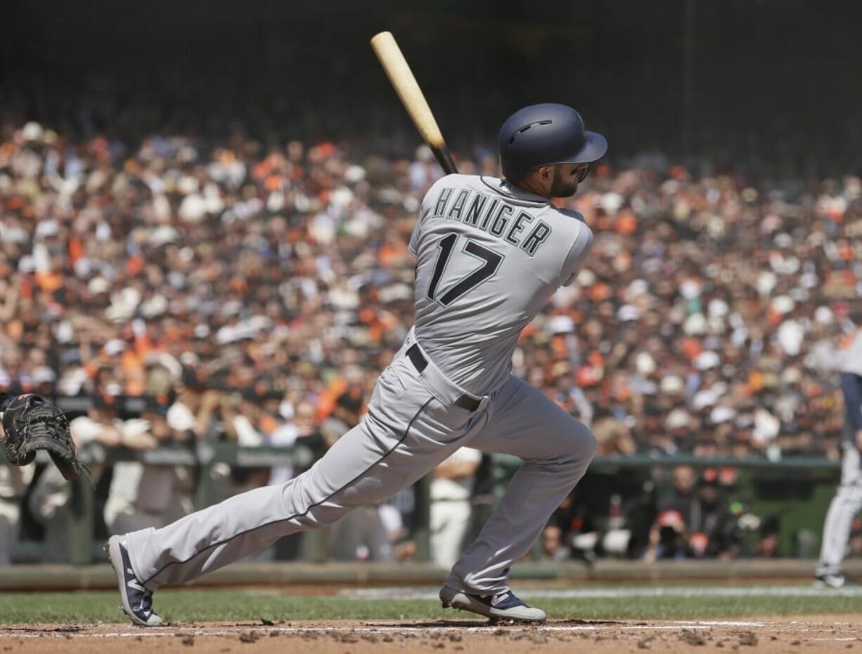 Seattle Mariners' Mitch Haniger hits a two RBI single off San Francisco Giants starting pitcher Ty Blach in the first inning of a baseball game Tuesday, April 3, 2018, in San Francisco.