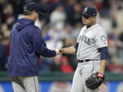 Seattle Mariners starting pitcher Erasmo Ramirez, right, hands the ball to manager Scott Servais during the sixth inning of the team’s baseball game against the Cleveland Indians, Friday, April 27, 2018, in Cleveland.