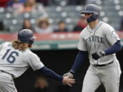 Seattle Mariners’ Ryon Healy, right, is congratulated by Ben Gamel after Healy hit a two-run home run off Cleveland Indians relief pitcher Dan Otero during the ninth inning of a baseball game, Saturday, April 28, 2018, in Cleveland. Gamel scored on the homer. The Mariners won 12-4.