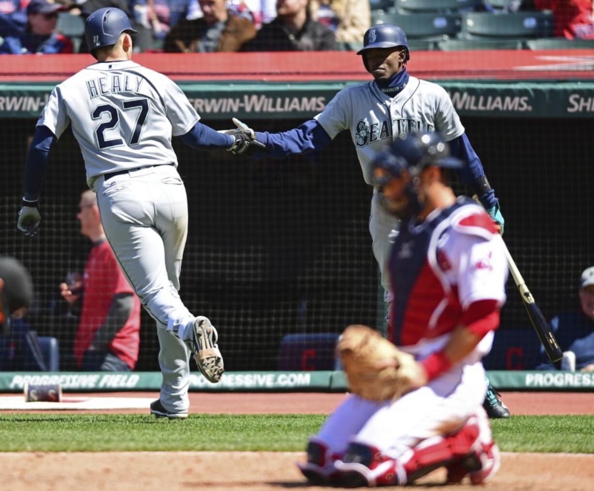 Seattle Mariners’ Ryon Healy, left, is congratulated by Dee Gordon after Healy hit a solo home run in the sixth inning of a baseball game against the Cleveland Indians, Sunday, April 29, 2018, in Cleveland.