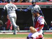 Seattle Mariners’ Ryon Healy, left, is congratulated by Dee Gordon after Healy hit a solo home run in the sixth inning of a baseball game against the Cleveland Indians, Sunday, April 29, 2018, in Cleveland.