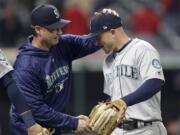 Seattle Mariners manager Scott Servais, left, congratulates Kyle Seager after the Mariners defeated the Cleveland Indians 5-4 Thursday in Cleveland.