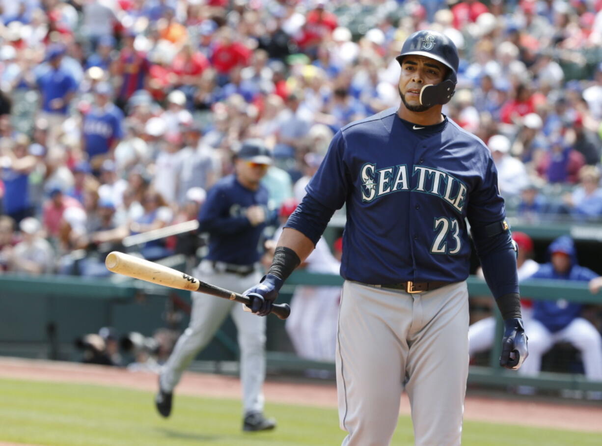 Seattle Mariners designated hitter Nelson Cruz (23) reacts after striking out against the Texas Rangers to end the third inning of a baseball game Sunday, April 22, 2018, in Arlington, Texas.