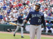 Seattle Mariners designated hitter Nelson Cruz (23) reacts after striking out against the Texas Rangers to end the third inning of a baseball game Sunday, April 22, 2018, in Arlington, Texas.