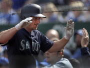 Seattle Mariners' Kyle Seager is greeted by teammates following his two-run home run during the eighth inning of a baseball game against the Kansas City Royals at Kauffman Stadium in Kansas City, Mo., Wednesday, April 11, 2018.