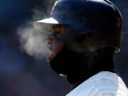 Minnesota Twins’ Miguel Sano generates steam as he breathes with the temperatures in the mid-20’s while on deck in the first inning of a baseball game against the Seattle Mariners Saturday, April 7, 2018, in Minneapolis.