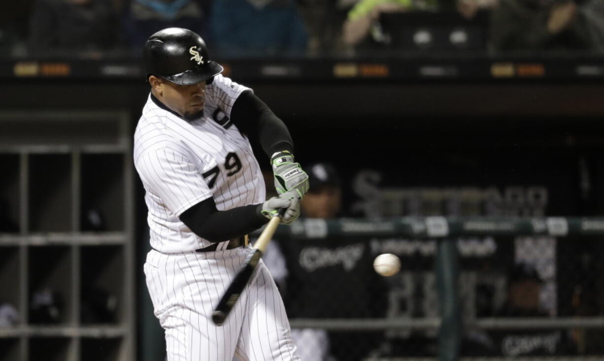 Chicago White Sox’s Jose Abreu hits a home run off Seattle Mariners relief pitcher Wade LeBlanc during the sixth inning of a baseball game Monday, April 23, 2018, in Chicago.