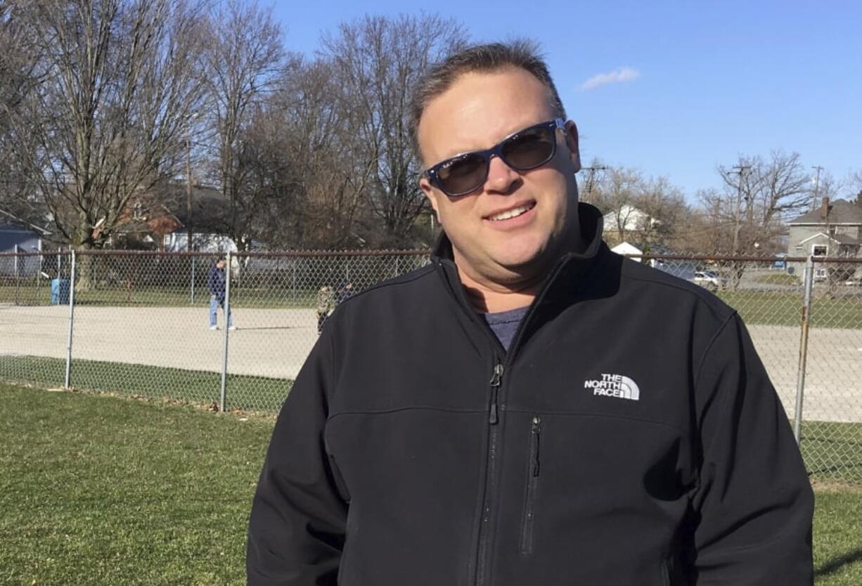 In this April 19, 2018, photo, automotive engineer Steve Semian speaks about Michigan’s political climate at his son’s baseball practice in Romeo, Mich. President Donald Trump will visit nearby Washington Township, where Semian lives in Macomb County, for a campaign rally this weekend.