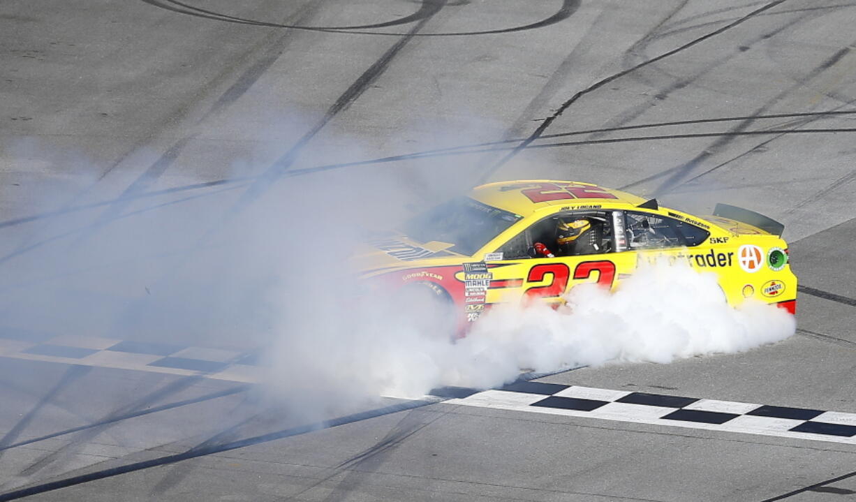 Joey Logano celebrates with a burnout after winning a NASCAR Talladega auto race at Talladega Superspeedway, Sunday, April 29, 2018, in Talladega, Ala.