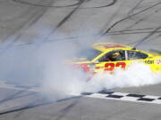 Joey Logano celebrates with a burnout after winning a NASCAR Talladega auto race at Talladega Superspeedway, Sunday, April 29, 2018, in Talladega, Ala.