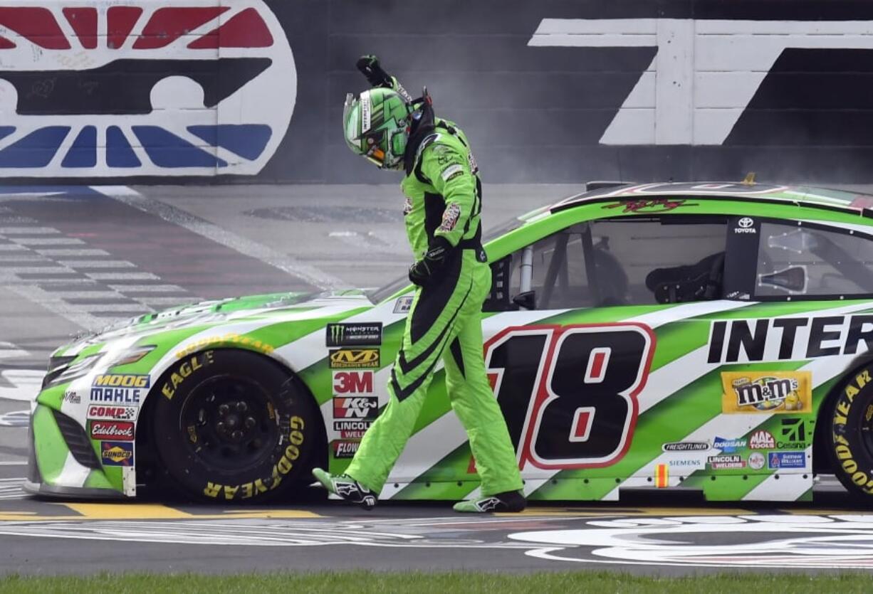 Kyle Busch (18) celebrates after winning a NASCAR Cup Series auto race in Fort Worth, Texas, Sunday, April 8, 2018.