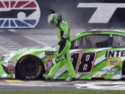 Kyle Busch (18) celebrates after winning a NASCAR Cup Series auto race in Fort Worth, Texas, Sunday, April 8, 2018.