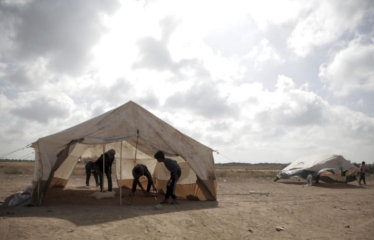 Palestinian protesters set up tents at the Gaza Strip’s border with Israel on Thursday. Palestinian activists are moving protest encampments closer to Israel’s fence ahead of mass demonstration.