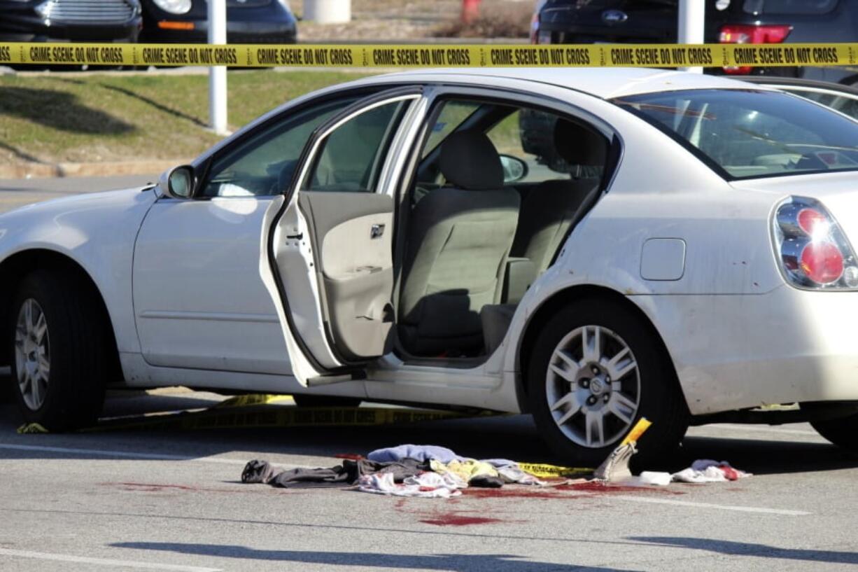 Police tape surrounds the scene where a 3-year-old girl accidentally shot and wounded her pregnant mother in a car parked outside a northwestern Indiana thrift store. The shooting happened Tuesday afternoon in Merrillville, Ind., as the girl, a 1-year-old boy and her mother waited in the car while the woman’s boyfriend was inside the store. Police say the man is the girl’s father and apparently left the loaded gun in the car.